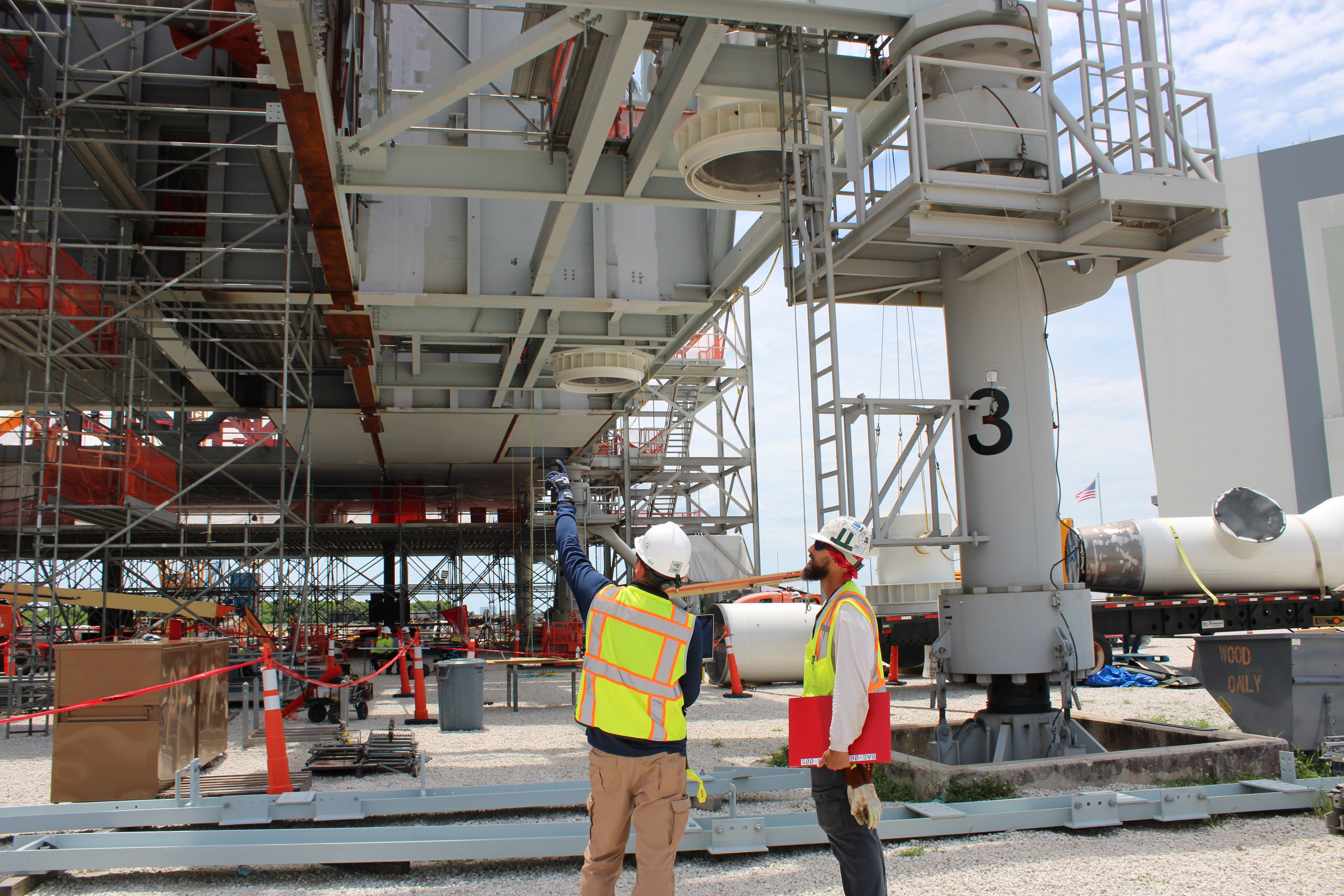 A Bechtel Field Engineer discusses base floor panel installation with the Ironworker General Foreman.