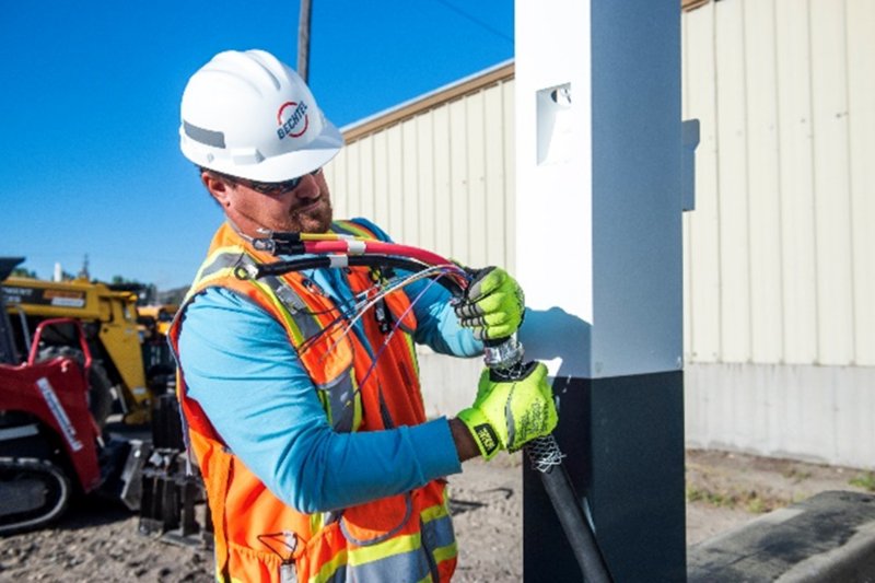 Bechtel Construction Coordinator Luke St. Martin installs electric charging stations for a school bus electrification project.